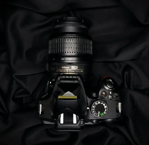 Nikon D3400 with 18-55mm lens on pitch black silk backdrop